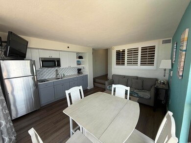 Dining space featuring dark wood-style floors