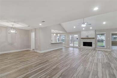 Open living and dining area with vaulted ceiling