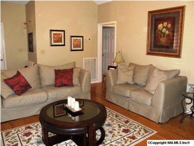VAULTED GREATROOM WITH TWO SIDED FIREPLACE AND HARDWOOD FLOORS