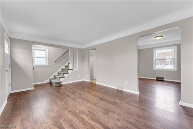 Unfurnished living room featuring dark hardwood / wood-style flooring