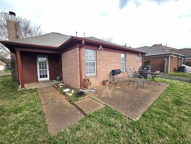 Rear view of house with a lawn, a patio, central A