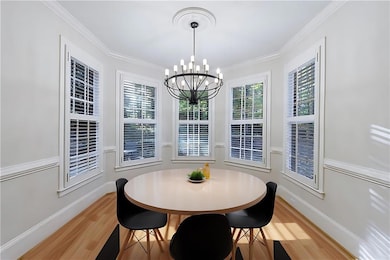 Dining area featuring crown molding, hardwood / wo