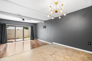 Unfurnished room with an inviting chandelier, a te