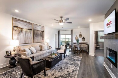 Living room with a ceiling fan, a tiled fireplace, dark wood-style floors, baseboards, and recessed lighting