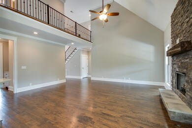 Stacked stone fireplace, grand catwalk, and soaring ceilings... want to see more?