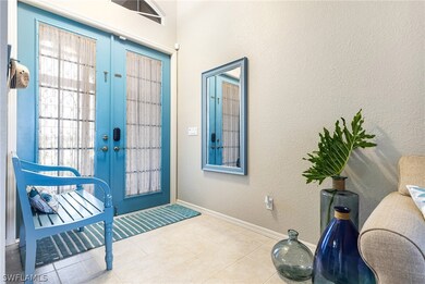 Foyer entrance with light tile patterned flooring and french doors