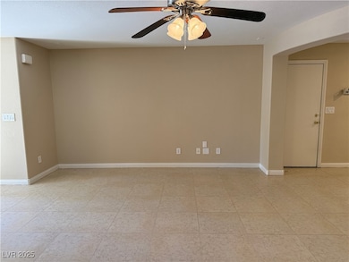 Unfurnished room featuring ceiling fan and baseboa