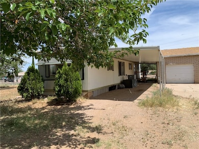 View of front of house featuring driveway and a ca