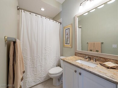 Bathroom with vanity, a shower with shower curtain