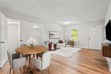 Dining area with light wood finished floors and ba