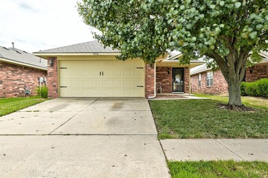 Ranch-style home with a garage and a front yard
