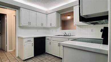Kitchen with dishwasher, light tile patterned flo