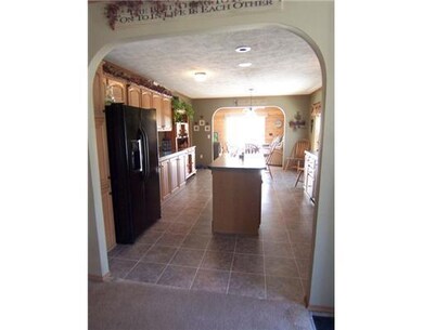 Kitchen. Graceful arch separates...