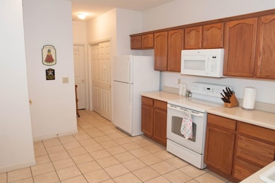 Kitchen featuring light tile patterned flooring an