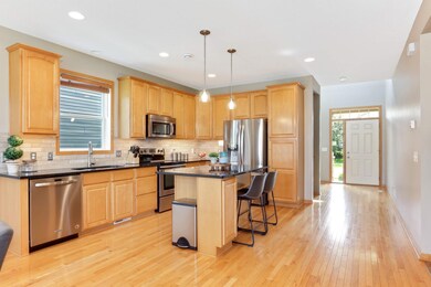 This kitchen has a great flow for entertaining and offers hardwood floors, center island and the granite countertops provide a sleek and durable surface.