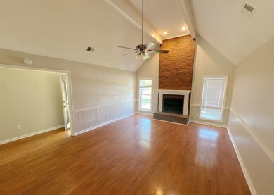 Unfurnished living room featuring lofted ceiling w
