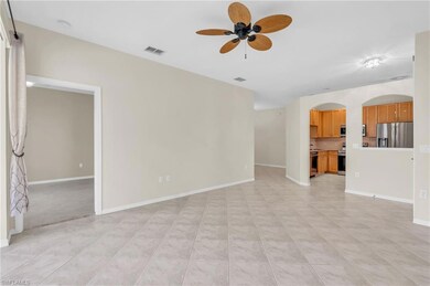 Unfurnished living room featuring ceiling fan and 