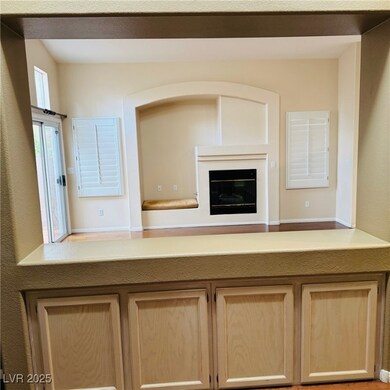 Kitchen with light brown cabinets and a glass cove