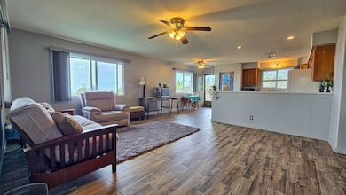 Spacious open living area with plenty room for ‘ohana gatherings—lots of natural light, cool island breezes, and a laid-back Hawai‘i vibe that’s perfect for relaxing or talk story after a long day.