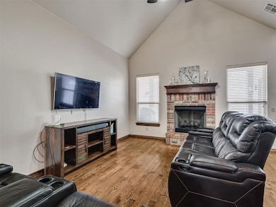 Living area with high vaulted ceiling, a brick fir