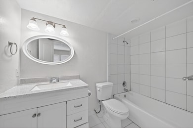 Attached primary bathroom with granite counter van