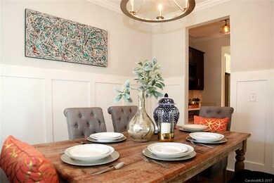 Formal dining room features custom paneling, desig