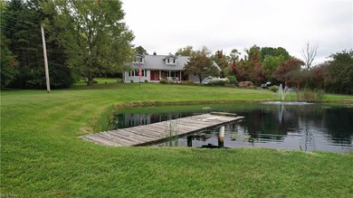 Dock area featuring a water view and a lawn
