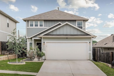 View of front of property featuring fence, drivew
