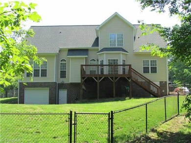 Exterior Back. Part of cleared 3 acres is fenced, balance is wooded - extra garage in basement, plus walk-in sealed crawl space