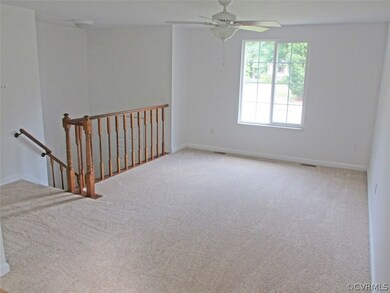 Large living room with ceiling fan.