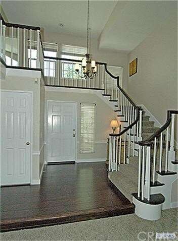 Formal entry with a wrap around stair case.
