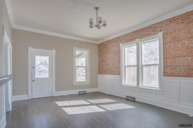 Living Room with Exposed Brick and Wainscoting