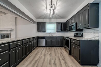 Kitchen featuring a fireplace, tasteful backsplash