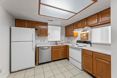 Kitchen with white appliances, under cabinet rang