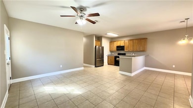 A view from the front entrance looking into the living room, kitchen and dining area. Did you notice the side door that leads to the side of the home and huge fenced in private backayard