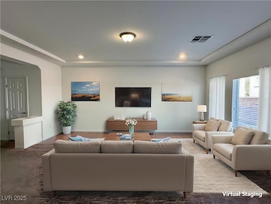 Living area with baseboards, a raised ceiling, and
