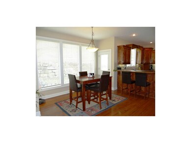The Open Breakfast Room With Hardwood Floors