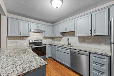 Renovated top-to-bottom in 2021, the kitchen boasts sleek cabinetry, stainless steel appliances, and quartz countertops. Designed with both beauty and functionality in mind, it opens seamlessly to the dining and living areas.