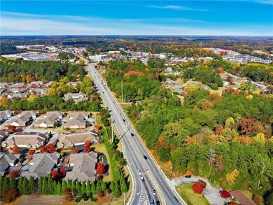 Aerial view of property's location with nearby suburban area
