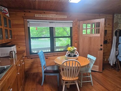 Dining room featuring hardwood / wood-style flooring, wooden ceiling, and wood walls