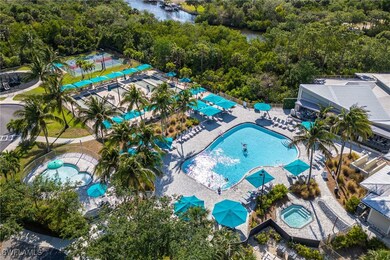 Aerial view of a pool area and a heavily wooded ar