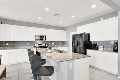 Kitchen featuring backsplash, stainless steel appl