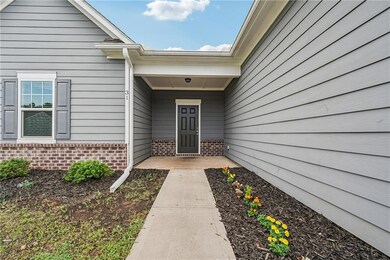 Property entrance featuring brick siding