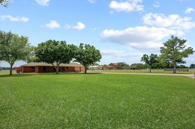Expansive green yard with mature trees, featuring