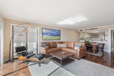 Living room featuring wood finished floors and ornamental molding