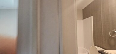 Full bathroom featuring a shower and toilet