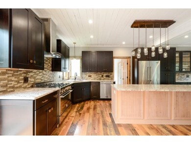 Barnwood floors, designer lighting, stunning tile 