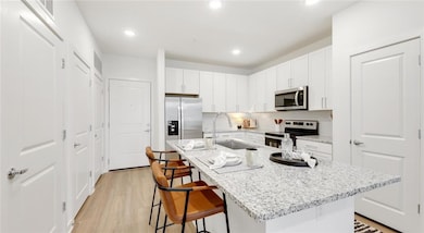Kitchen with sink, light hardwood / wood-style flo