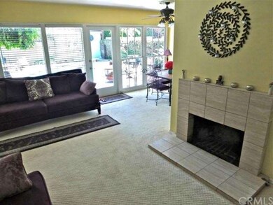 Fireplace in living room with view through full wa