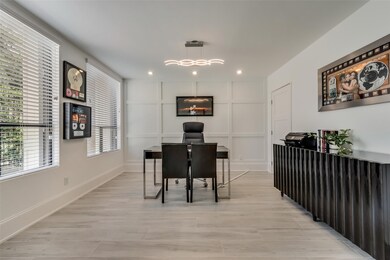 The office with wood accent wall has a storage clo